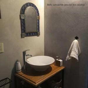 a bathroom with a sink and a mirror at Cabañas Yei Calli in Ciudad Mendoza