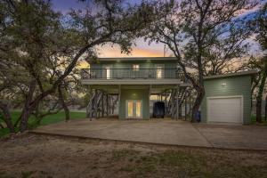 a large house with a porch and a garage at Lake Travis with Private Dock on Deep Water Cove in Lago Vista
