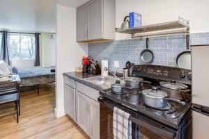 a kitchen with pots and pans on the stove at Studio w/ King Bed near Dwtn in Rochester