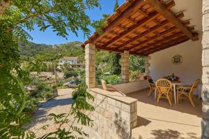 a patio with a table and chairs and a pergola at Apartments by the sea Okuklje, Mljet - 22340 in Maranovići