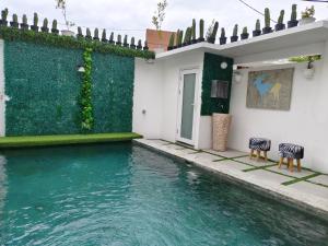 a house with two zebra chairs next to a swimming pool at Omahati Villa Brawa in Dalung