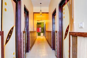 a hallway of a house with wooden doors at OYO ALASKA HOTEL in Alwar