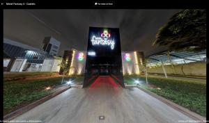 a sign that is lit up at night at Motel fantasy 4 (adult Only) in Belo Horizonte