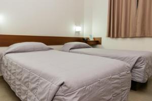 Postel nebo postele na pokoji v ubytování Hotel Fernandão