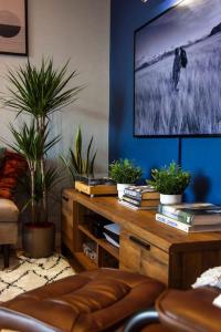 a living room with potted plants and a tv at Cozy Urban Retreat in London in London