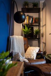 salon ze skórzanym krzesłem i lampą w obiekcie Cozy Urban Retreat in London w Londynie