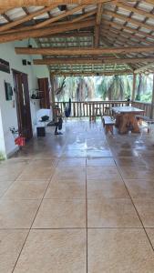 a large room with a table and benches at Pousada Sempre Luz in Santana do Riacho