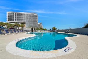 a swimming pool with chairs and a building in the background at North Hampton #331 in Myrtle Beach