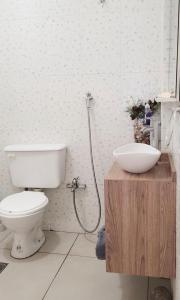 a bathroom with a toilet and a sink at -AMBIENTE BOTIQUE- Tu lugar ideal- in Santiago del Estero