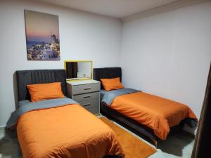 a bedroom with two beds and a dresser and a mirror at Taksim Square Residence, Two bedrooms, pool sauna gym in Istanbul +21 photos