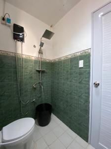 a bathroom with a shower and a toilet at Can accommodate up to 10 guest near Virac Airport in Virac