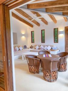 a living room with a table and chairs at Casa Mon Repos en Careyes in Careyes