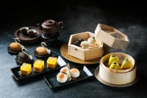 a table with plates of food and a box of food at Sheraton Hong Kong Hotel & Towers in Hong Kong