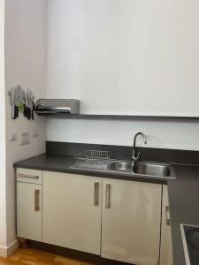 a kitchen with a sink and a counter top at Spacious flat next to central station in Glasgow