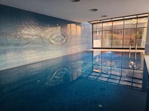 a swimming pool with a reflection in the water at Taksim Square Residence, Two bedrooms, pool sauna gym in Istanbul