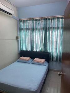 a small bed in a room with a window at CLP Perai Homestay Apartment in Chai Leng park in Perai