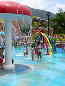 a group of children playing in a water park at Jayuya Cozy Aparment with Wi-Fi, Free Parking and AC in Jayuya