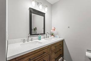 a bathroom with a sink and a mirror at Renovated 3BR Retreat with Large Patio & Grill in Charlotte +9 photos