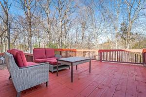 a patio with two chairs and a table on a deck at Renovated 3BR Retreat with Large Patio & Grill in Charlotte