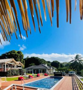 a view of a house and a swimming pool at Red Hibiscus Villas in Rarotonga +17 photos