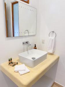 a bathroom with a white sink and a mirror at Casa Mon Repos en Careyes in Careyes