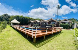 a boat sitting on the grass in front of some houses at Red Hibiscus Villas in Rarotonga
