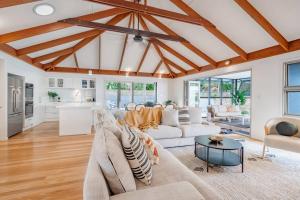 a living room with a couch and a table at Luxurious Beachside Living in Mudjimba