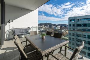 a balcony with a table and chairs and a view at Spacious 1-Bed with View in Central Location in Canberra