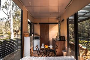 a tiny house with a kitchen and a balcony at River's Edge at The White House on Bowman in Barrington