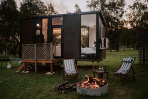 a tiny house with a fire in a yard at Willow Dale Farm in Paterson