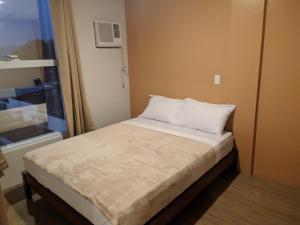 Postel nebo postele na pokoji v ubytování D' Loft Iligan