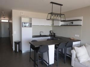 a kitchen with a table and chairs in a room at Appartement luxe avec piscine, animaux admis, climatisation et parking à La Tranche-sur-Mer - FR-1-194-227 in La Tranche-sur-Mer