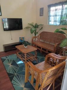 a living room with a couch and a table and chairs at Family Retreat in Paradahan