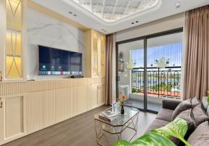 a living room with a couch and a tv at Saigon Royal Apartment in Ho Chi Minh City