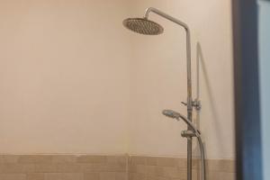een douche met een douchekop in de badkamer bij Nusa Penida Homestay in Nusa Penida
