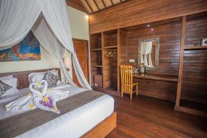 Postel nebo postele na pokoji v ubytování D'Muncuk Huts Lembongan