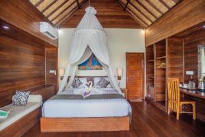 Postel nebo postele na pokoji v ubytování D'Muncuk Huts Lembongan