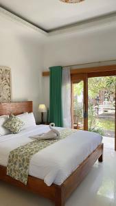 a bedroom with a large bed and a window at Nusa Indah Bungalow in Nusa Lembongan