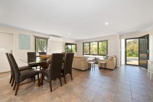 a living room with a dining room table and chairs at Seaside Sanctuary in Tootgarook