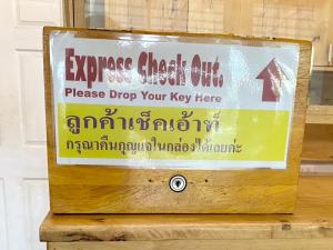 a sign that saysaza cheat oil please drop your key here at Lee Place Phatthanakan Condo in Bangkok