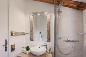 a bathroom with a sink and a shower at Beautiful Apartment Hortensia with large terrace for 46 people in Calvi