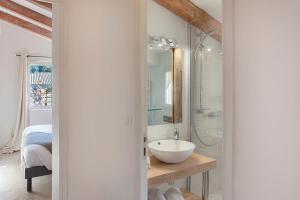 a bathroom with a sink and a glass shower at Beautiful Apartment Hortensia with large terrace for 46 people in Calvi