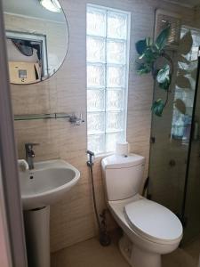 a bathroom with a toilet and a sink and a mirror at Hoan Kiem lake center in Hanoi