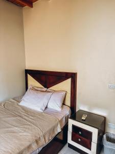 a bedroom with a bed and a side table at The Cage in Dahab