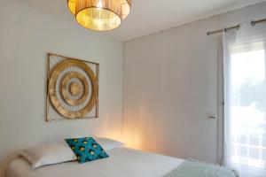 a bedroom with a bed and a picture on the wall at Apartment "Jasmin" 3 bedrooms with large terrace 68 people in Calvi