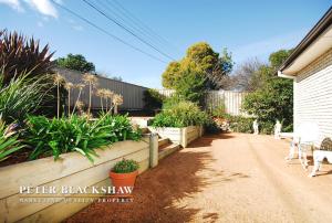 a garden with plants and chairs in a yard at Convenience location with large living areas in Kambah