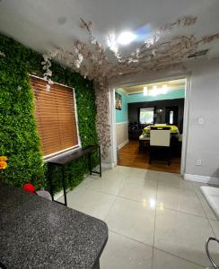 a living room with a green wall and a table at mary jane room in Miami