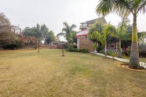 a yard with a net in front of a house at Aravali hills resort in Gurgaon