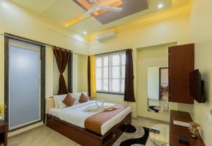 a bedroom with a bed and a large window at Silver Galaxy Resort in Panchgani