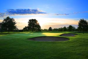 a golf course with two holes in the grass at Belton Woods Hotel, Spa & Golf Resort in Grantham